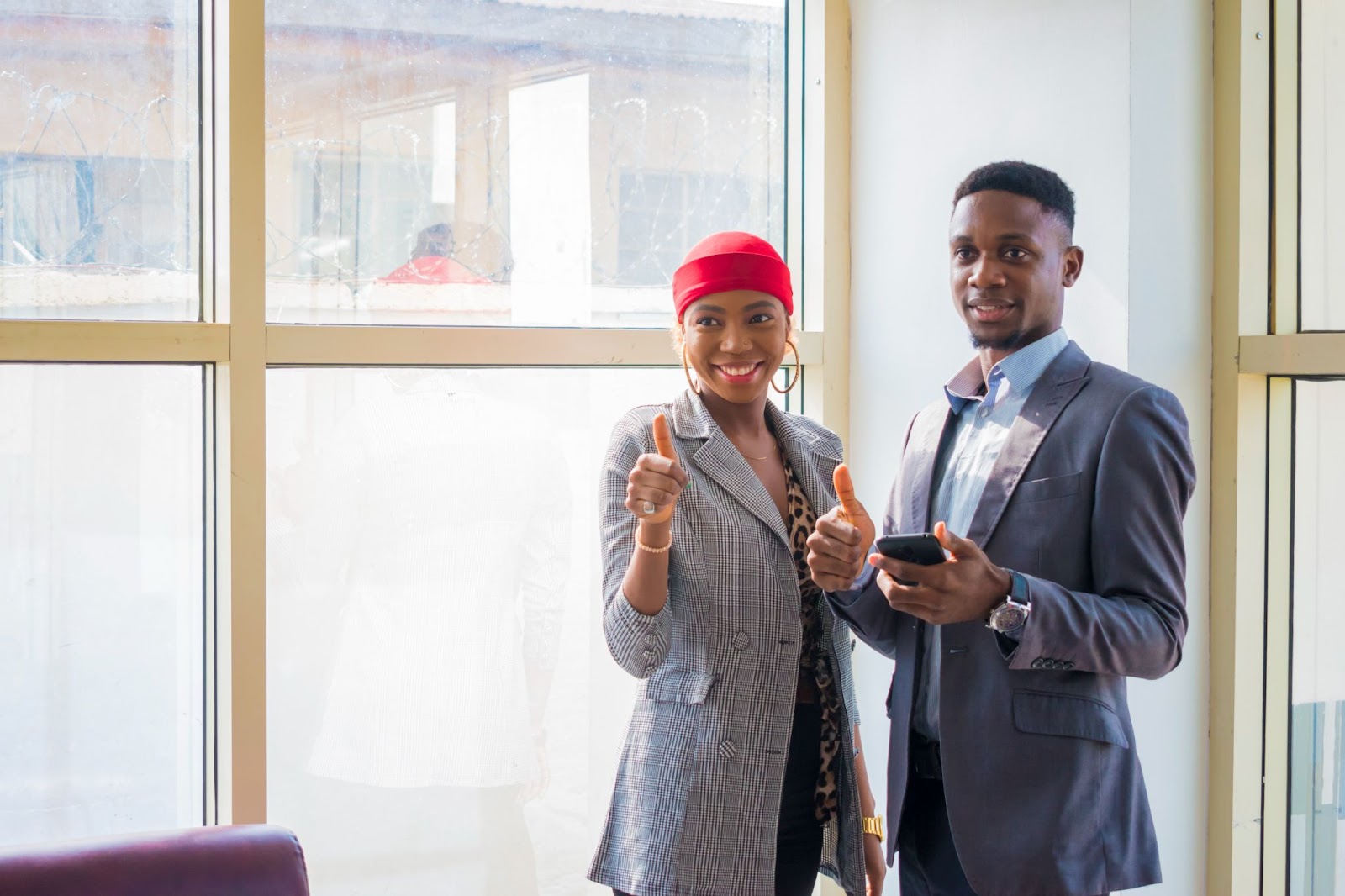 two people holding mobile in office 